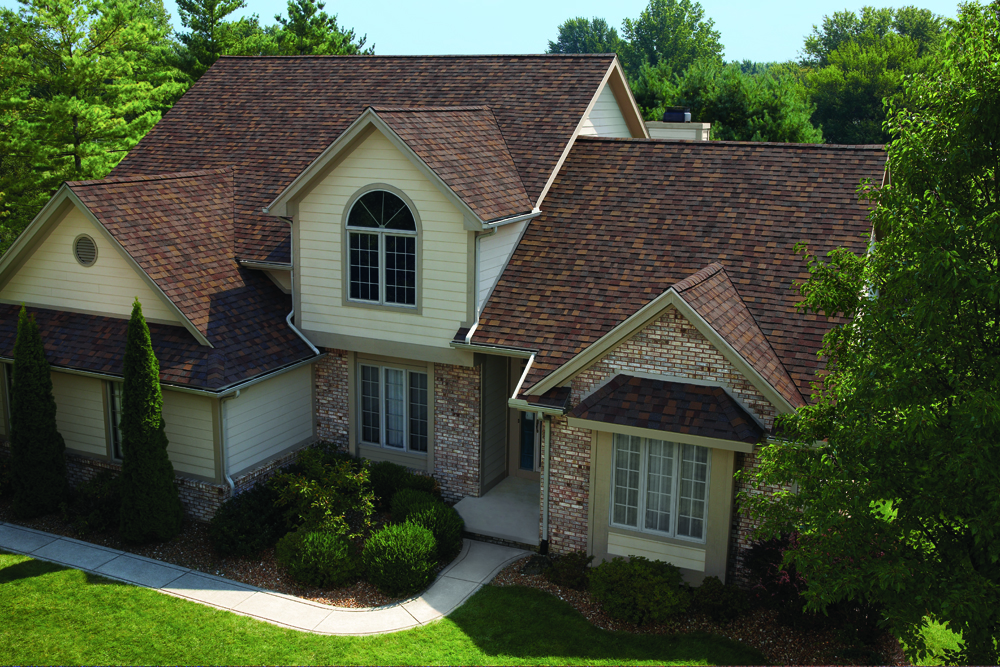 Close-up of a gray architectural shingle roof in sunlight